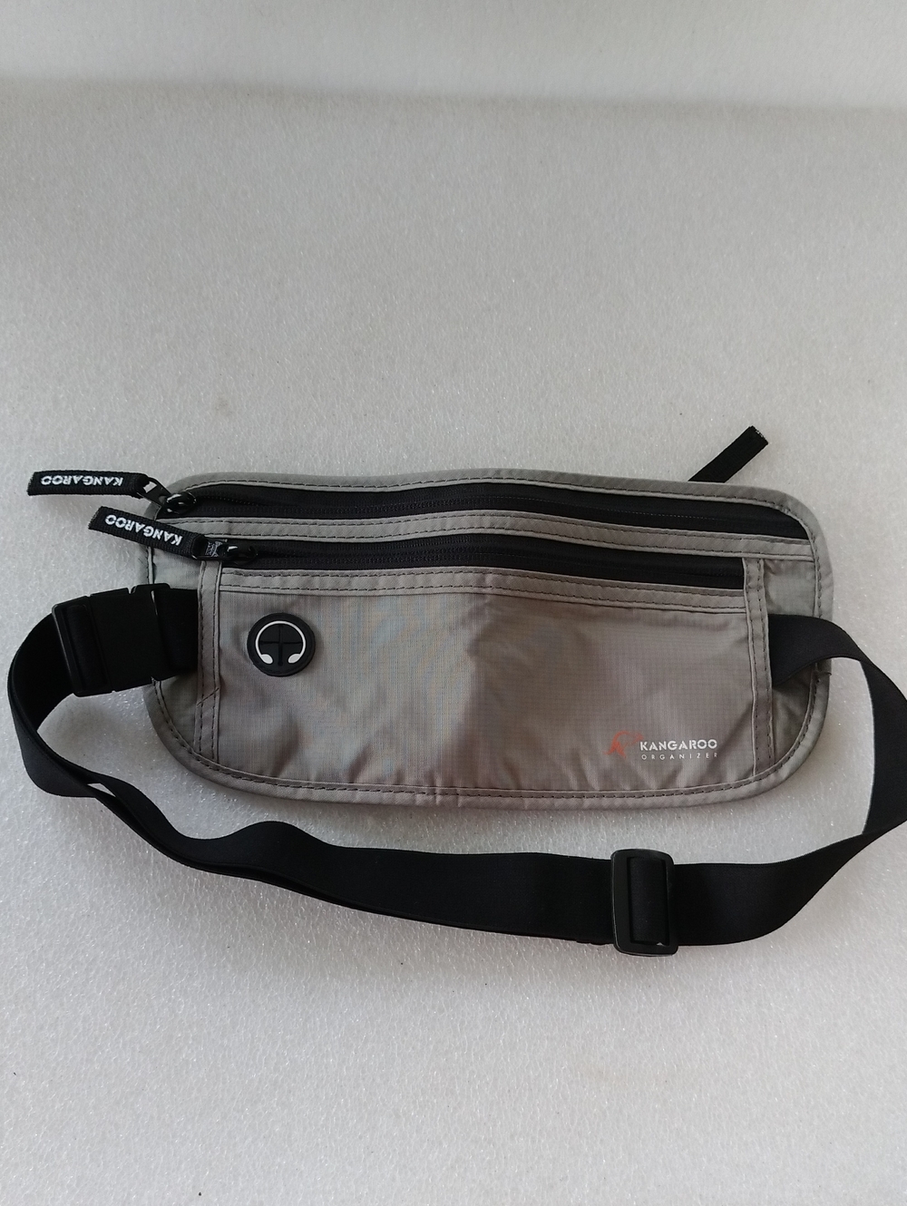 Kangaroo branded gray, slim fanny pack for travel with multiple zippered pockets